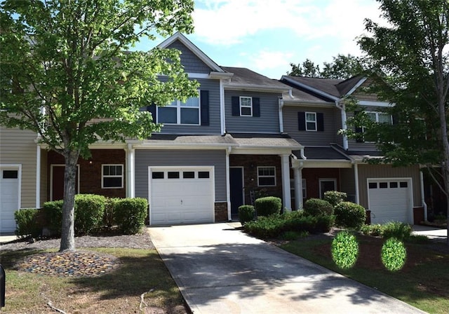532 Oakside Pl, Acworth, GA 30102 - view of front facade with an attached garage, concrete driveway, and stone siding