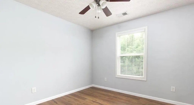 532 Oakside Pl, Acworth, GA 30102 - empty room with baseboards, dark wood-type flooring, ceiling fan, and a textured ceiling