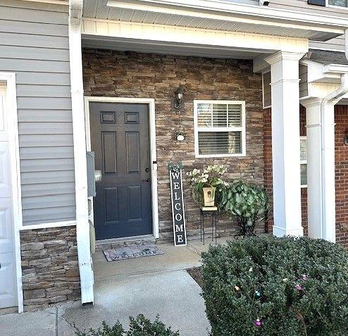 532 Oakside Pl, Acworth, GA 30102 - doorway to property featuring a porch and stone siding
