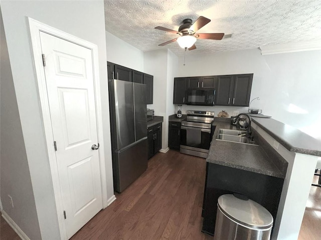 532 Oakside Pl, Acworth, GA 30102 - kitchen featuring appliances with stainless steel finishes, a sink, ceiling fan, a textured ceiling, and dark wood-style flooring