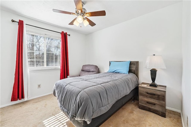 bedroom featuring light carpet, ceiling fan, and baseboards