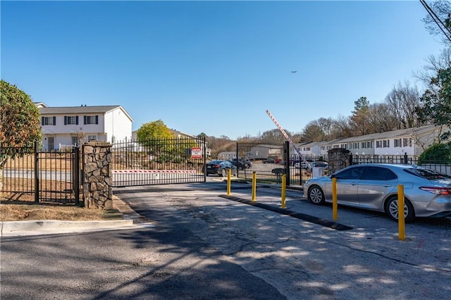 1625 Conley Rd Unit 270, Conley, GA 30288 - view of asphalt road with a residential view, curbs, a gated entry, and a gate