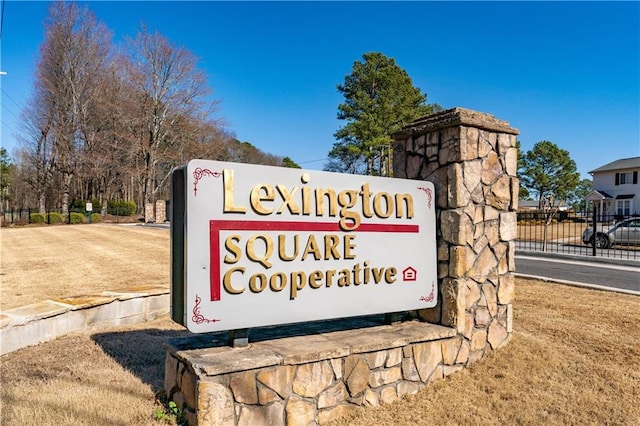 community / neighborhood sign featuring fence