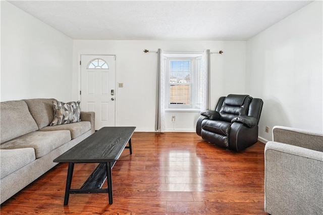 living room featuring dark wood finished floors and baseboards