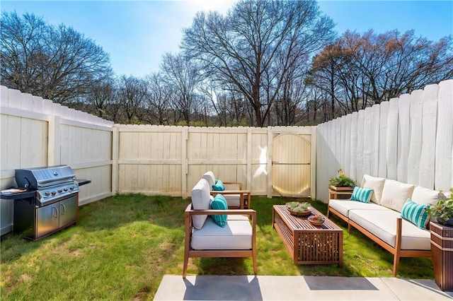 view of yard with a gate, outdoor lounge area, and a fenced backyard