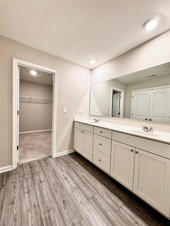 bathroom with vanity and hardwood / wood-style flooring