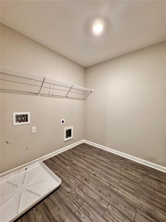 laundry room with dark wood-type flooring, electric dryer hookup, and washer hookup