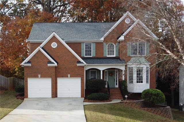 front of property with a garage and a front yard