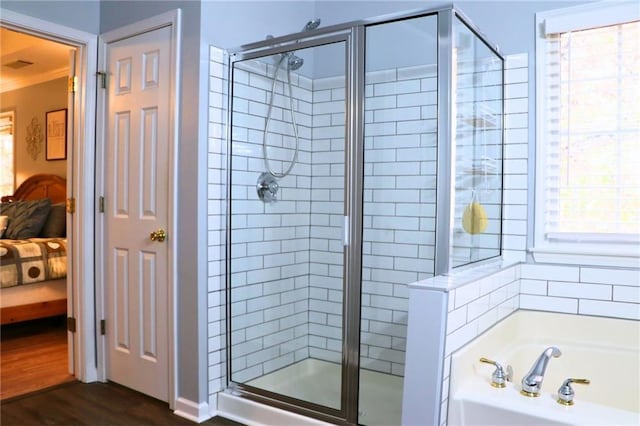 bathroom featuring wood-type flooring and separate shower and tub