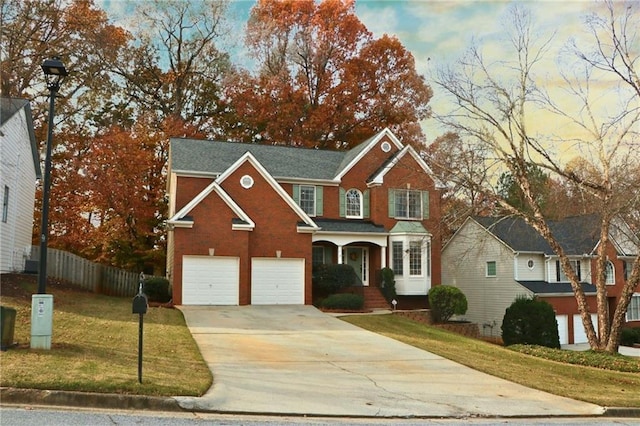 view of front of property with a garage and a yard