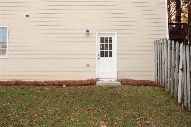 view of exterior entry with a yard