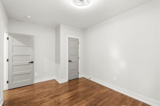 unfurnished bedroom with dark hardwood / wood-style flooring