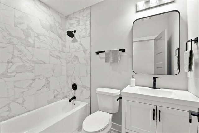 full bathroom featuring vanity, tiled shower / bath combo, and toilet