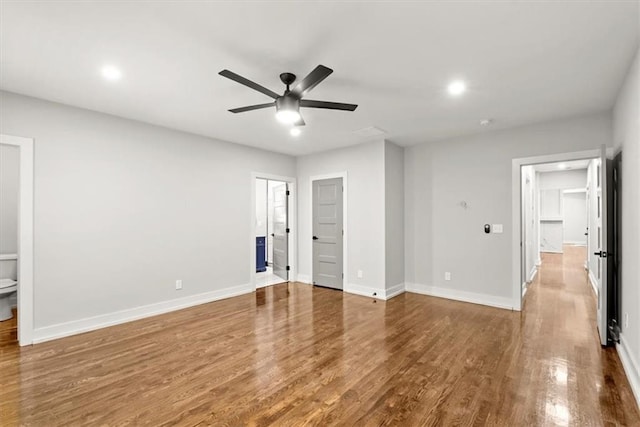 unfurnished bedroom with wood-type flooring, ensuite bath, and ceiling fan