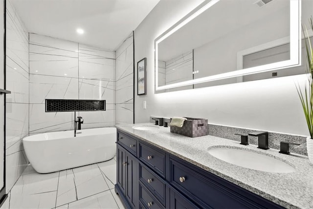 bathroom with vanity and a bath