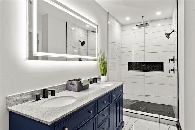 bathroom with vanity and a tile shower