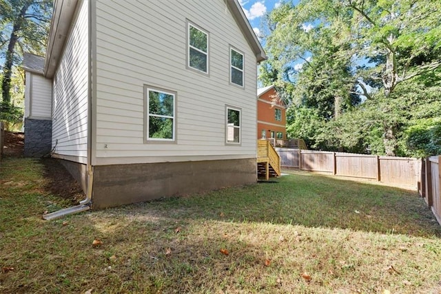 rear view of property featuring a lawn