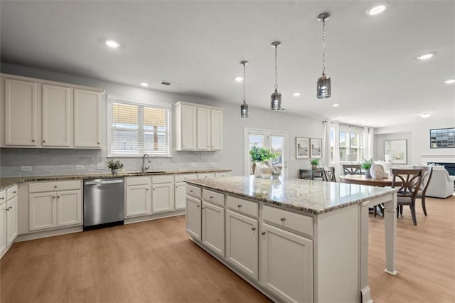 7410 Ansley View Ln, Cumming, GA 30028 - kitchen with stainless steel dishwasher, recessed lighting, light wood-style flooring, a center island, and backsplash