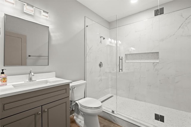 7410 Ansley View Ln, Cumming, GA 30028 - bathroom with a marble finish shower, vanity, and wood finished floors