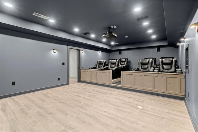 7410 Ansley View Ln, Cumming, GA 30028 - cinema with light wood-style floors, a raised ceiling, a barn door, and recessed lighting