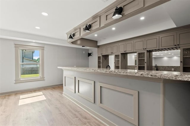 7410 Ansley View Ln, Cumming, GA 30028 - kitchen featuring light wood-style flooring, recessed lighting, and light stone counters