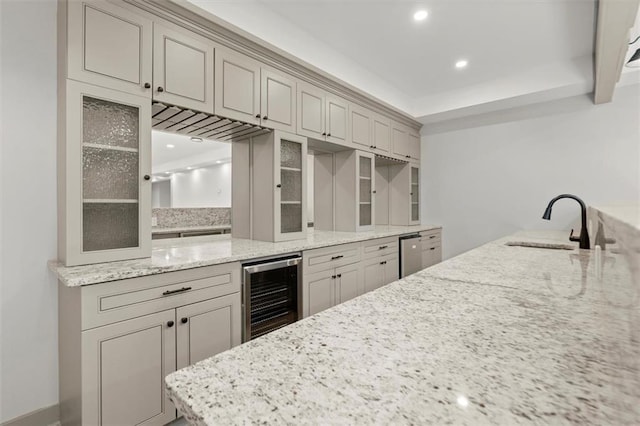 7410 Ansley View Ln, Cumming, GA 30028 - kitchen featuring wine cooler, glass insert cabinets, light stone counters, and recessed lighting