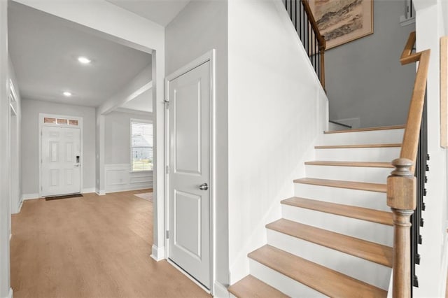 7410 Ansley View Ln, Cumming, GA 30028 - foyer entrance featuring stairs, wood finished floors, recessed lighting, and a wainscoted wall