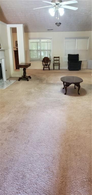 999 Simonton Glen Dr, Lawrenceville, GA 30045 - living area featuring ceiling fan, light colored carpet, and a premium fireplace