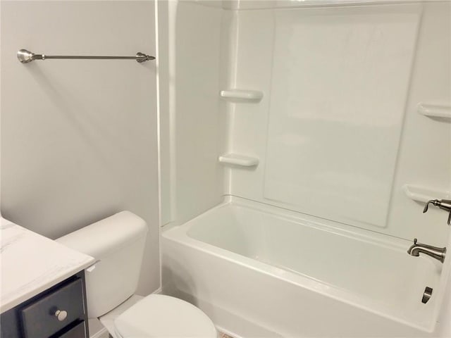 bathroom featuring  shower combination, vanity, and toilet