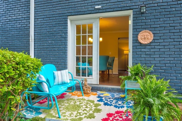 property entrance featuring brick siding
