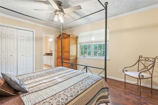 bedroom featuring wood finished floors, a textured ceiling, a closet, baseboards, and crown molding