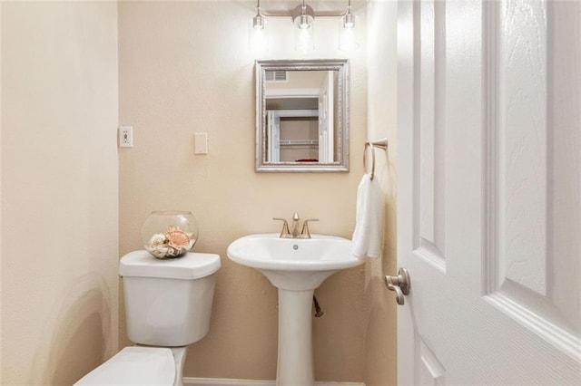 bathroom with toilet and a sink