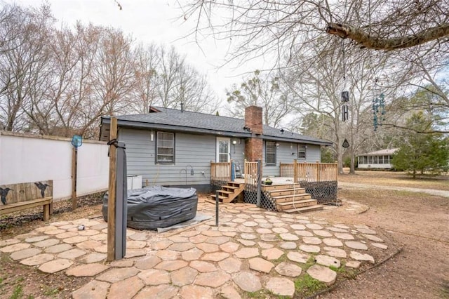 back of house with a patio and a deck