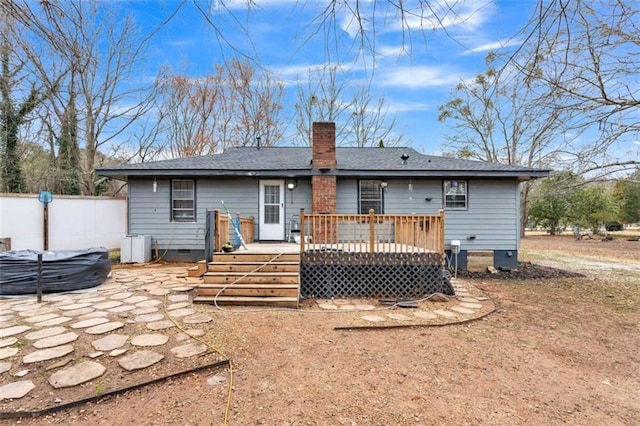 rear view of property featuring a patio and a deck