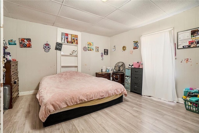 bedroom with hardwood / wood-style floors and a drop ceiling