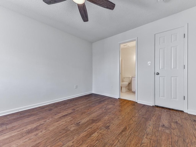 unfurnished bedroom featuring hardwood / wood-style floors, ensuite bath, a textured ceiling, and ceiling fan