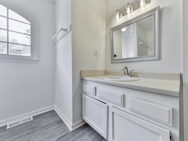 bathroom with vanity and hardwood / wood-style floors