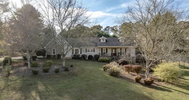 new england style home with a front yard and a porch