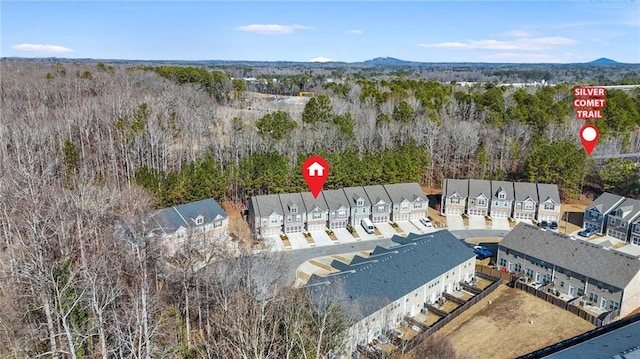 birds eye view of property with a residential view and a view of trees