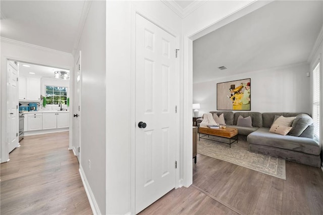 5552 Knox Pl, Peachtree Corners, GA 30092 - corridor with light wood-type flooring, crown molding, baseboards, and a sink