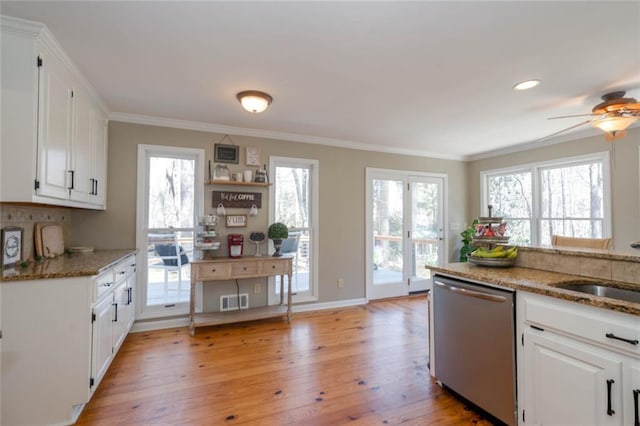 kitchen with dishwasher, light wood-style flooring, light stone counters, ornamental molding, and white cabinetry