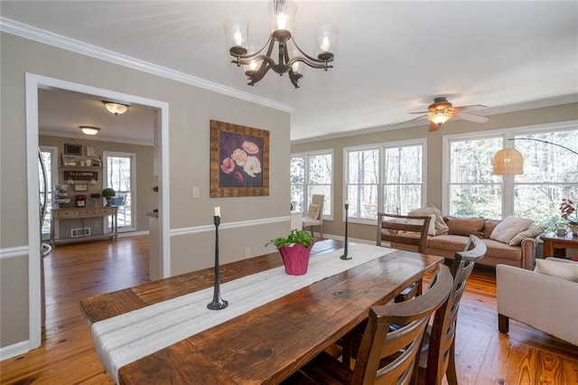 dining room with crown molding, visible vents, and wood finished floors