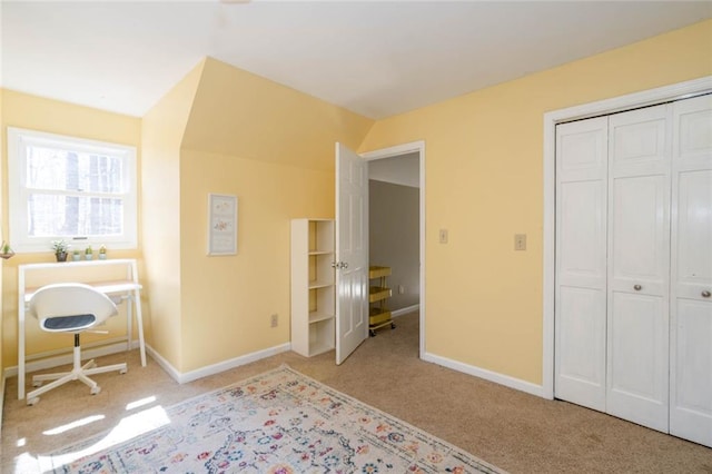 unfurnished bedroom with a closet, light carpet, and baseboards