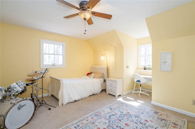 bedroom featuring multiple windows, light carpet, and baseboards