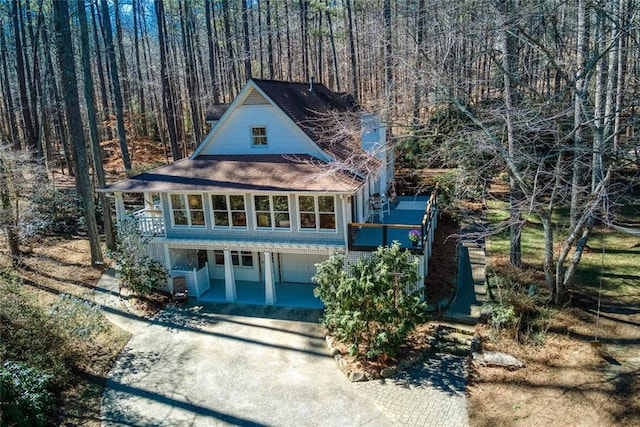 view of front of house with driveway, an attached garage, and stairway