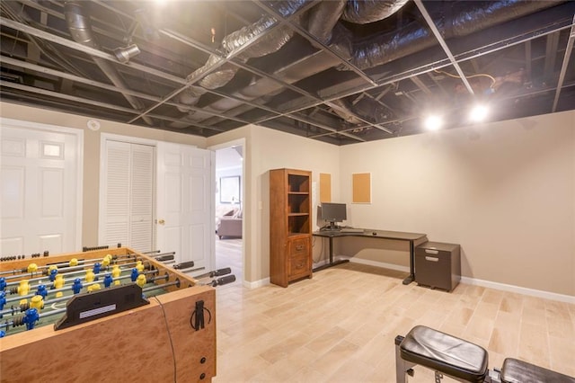 game room with baseboards and wood finished floors