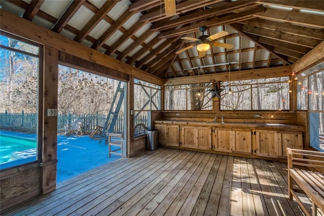 unfurnished sunroom with lofted ceiling and ceiling fan