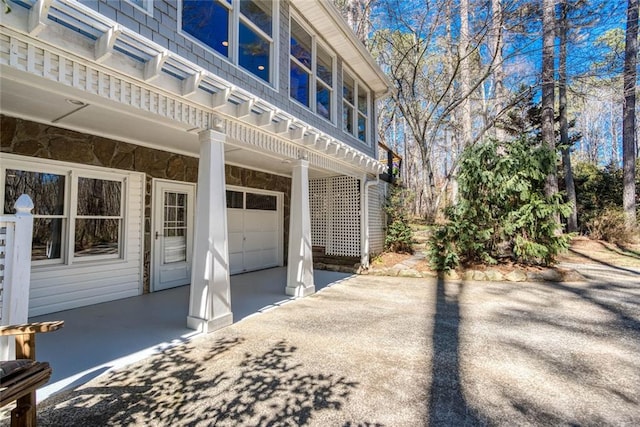 view of side of property with driveway and a garage