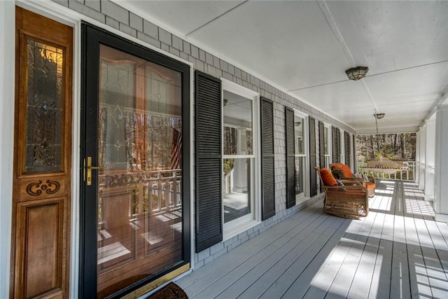 wooden terrace featuring covered porch