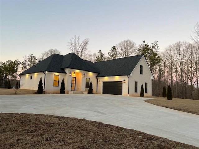 view of front of home featuring a garage and concrete driveway